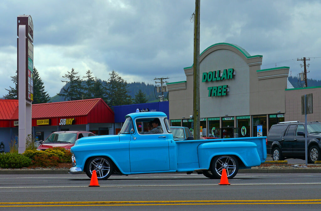 Colorful rhododendron festival parade float decorated with pink flowers moving through Florence Oregon coastal town